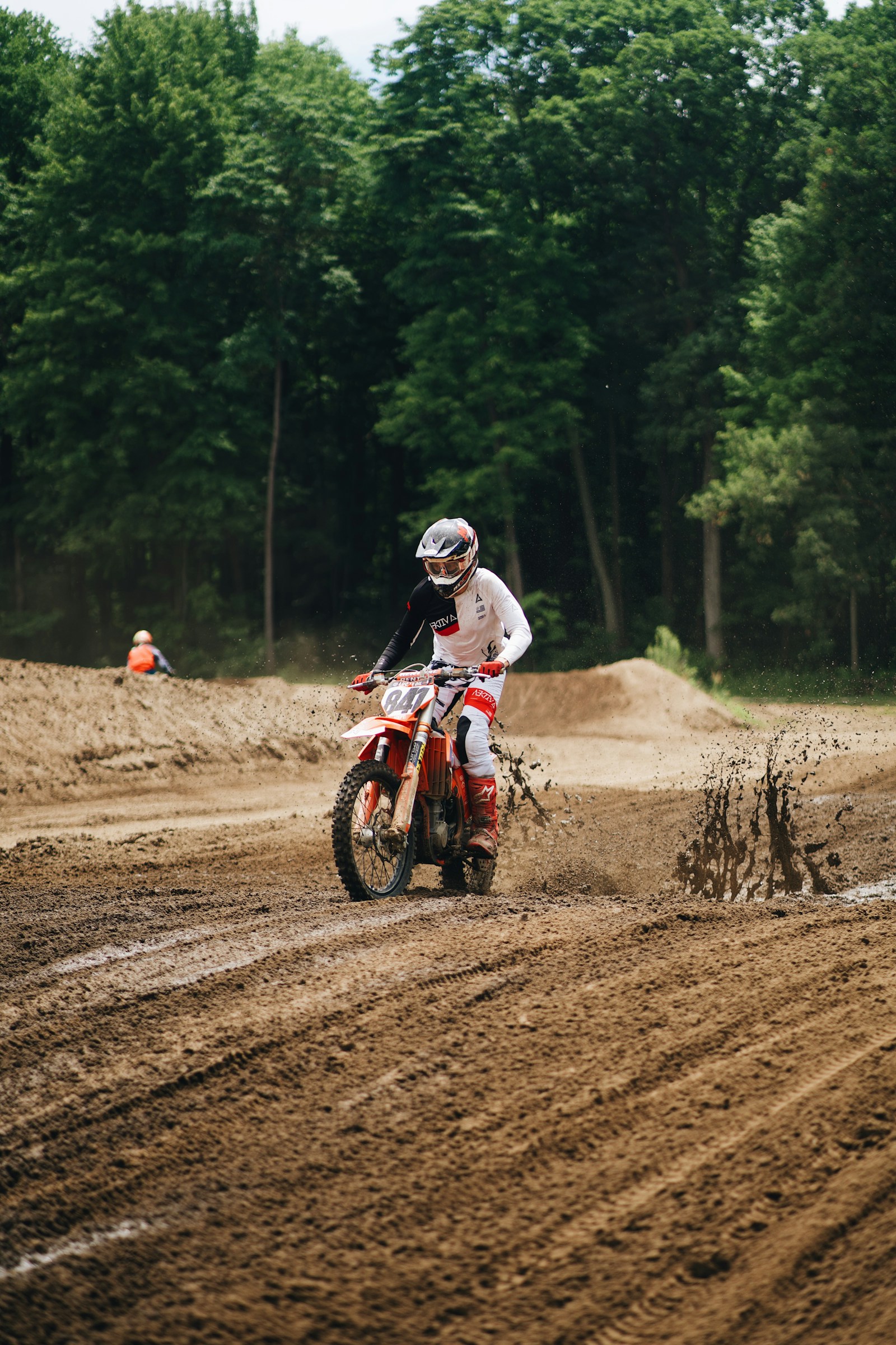 Motocross rider carving a turn on a dirt track
